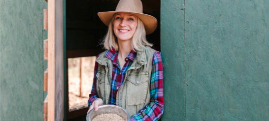 a woman in a cowboy hat and plaid shirt